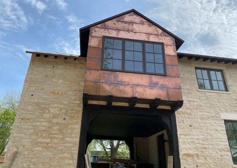 Copper metal panel facade on a stone building for Metal Roof Coating in Suamico