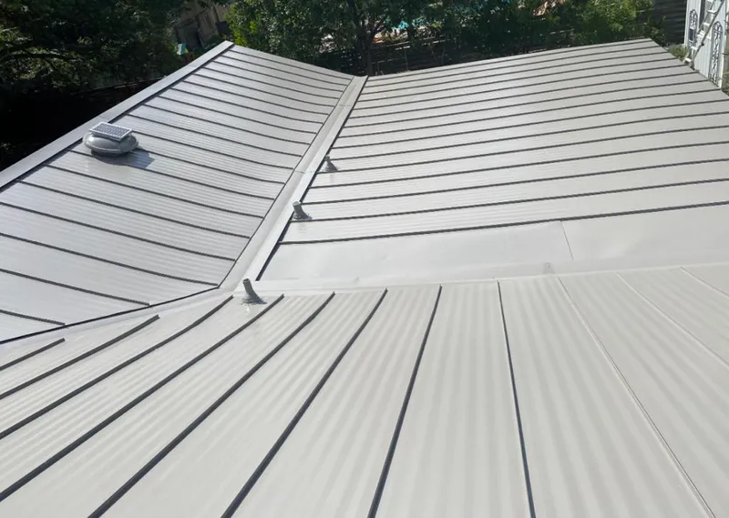 Solar attic fan installed on a metal roof for Roof Ventilation in Suamico